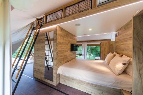 a bedroom with a bunk bed with a ladder at Villaggio La Pescaccia in San Clemente