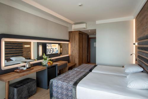 a hotel room with a bed and a desk at Riviera Zen Hotel Adult Only in Alanya