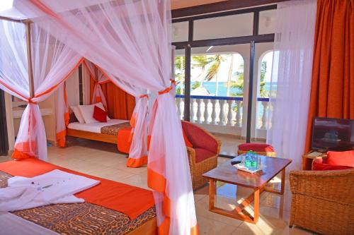 a living room with a bed and a table at Ocean View Nyali Boutique Hotel in Nyali