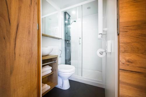 a bathroom with a toilet and a glass shower at Villaggio La Pescaccia in San Clemente