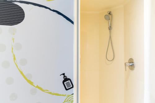 a bathroom with a shower with a shower head at ibis budget Paris Porte de Vincennes in Paris