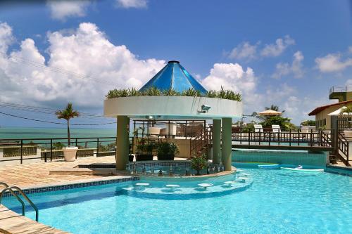 a swimming pool with a gazebo in a resort at Hotel Costa do Atlantico in Natal