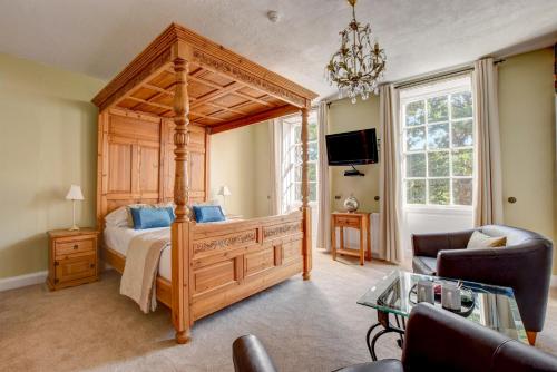 a bedroom with a canopy bed and a living room at White Linen Whitby, Room Only in Whitby