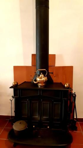 a black stove with a pot on top of it at Borgo Vecchio in Carbognano