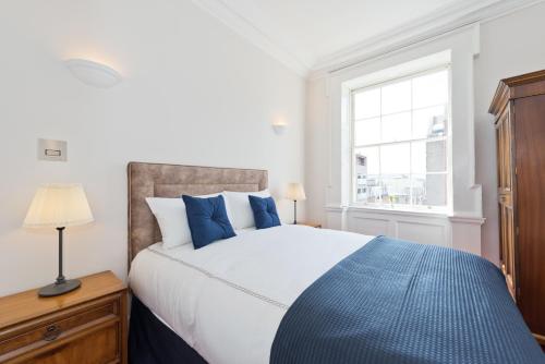 a bedroom with a large bed and a window at Henrietta Suites City Centre in Dublin