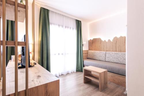 a living room with a couch and a table at Hotel Montana in Vason