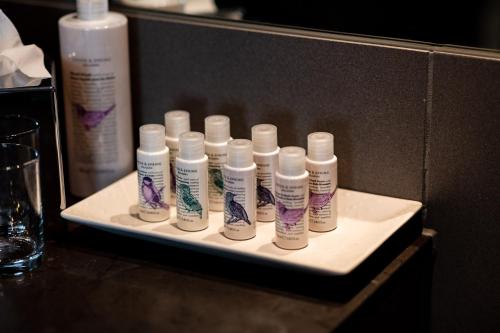 a tray with four bottles of moisturizers on a table at Rose And Crown Hotel in London