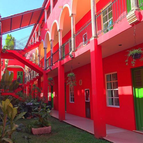 a row of red buildings with balconies at Hotel Mejorada Merida in Mérida