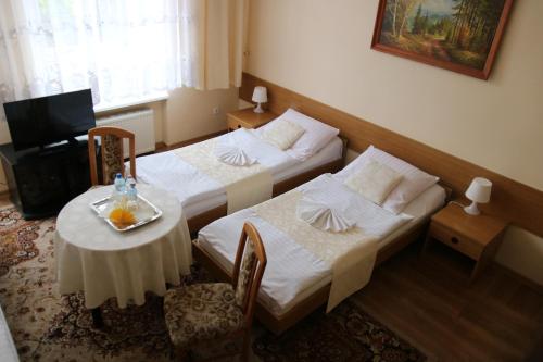 Postel nebo postele na pokoji v ubytování Hotel Polonia
