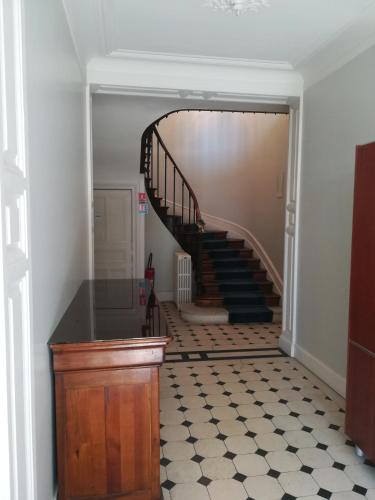 a hallway with a spiral staircase in a house at Manoir de Bolbec in Bolbec