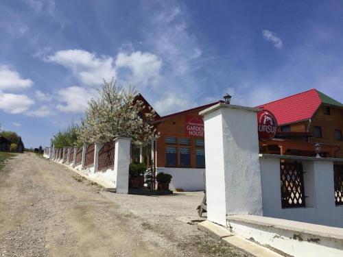 a building on the side of a dirt road at Transilvania Garden House in Miercurea-Ciuc