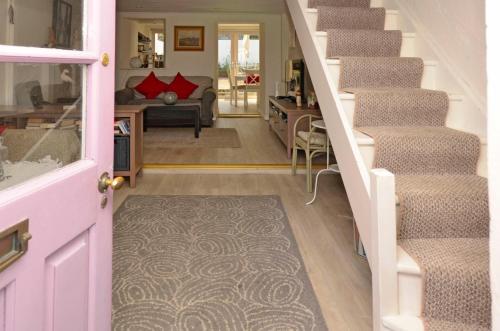 a hallway with stairs and a living room at Cottage 170 - Roundstone in Roundstone