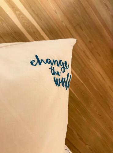 a pillow with the words change the world on it at Change The World Hostels - Coimbra - Almedina in Coimbra