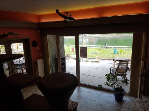 a living room with a sliding glass door to a patio at Panama RIO in Waulsort