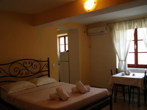 a bedroom with a bed and a table and a window at La Casa di Nonna in Qeparo