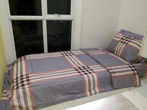 a bed in a room with a window at Strait Garden Suites X Ace Pro @ George Town in Jelutong