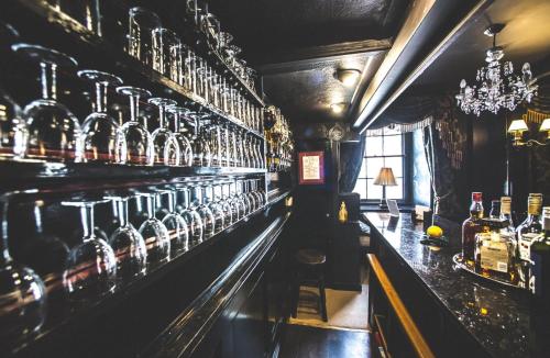 a bar with a row of wine bottles at Jeakes House in Rye