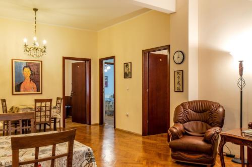 a living room with a chair and a table at Casa Ferrari Bed & Breakfast in Sofia