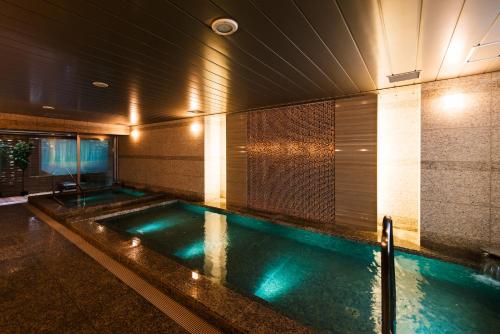 a swimming pool with blue lights in a building at Super Hotel Premier Tokyo Station Yaesu-Chuoguchi in Tokyo