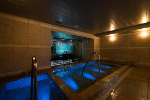 a jacuzzi tub with blue lights in a room at Super Hotel Premier Tokyo Station Yaesu-Chuoguchi in Tokyo