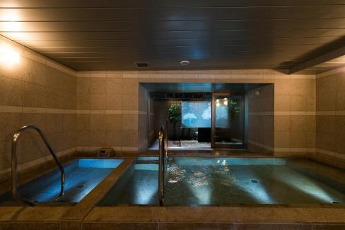 a bath tub in a room with at Super Hotel Premier Tokyo Station Yaesu-Chuoguchi in Tokyo