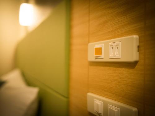 a light switch on a wall in a room at Super Hotel Premier Tokyo Station Yaesu-Chuoguchi in Tokyo