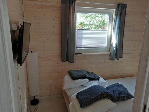 a room with two beds in a wooden room with a window at Apartament Antonio 1 Gdańsk in Gdańsk