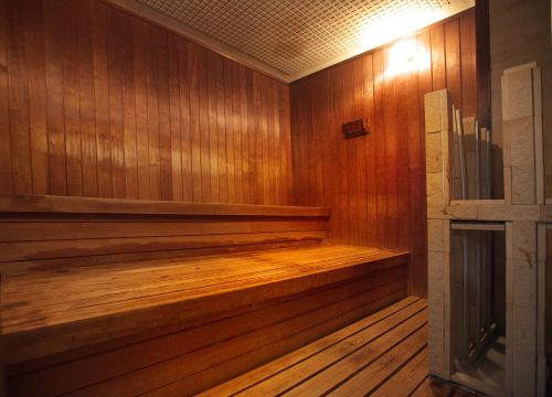 a sauna with wood paneled walls and a wooden floor at Amami Port Tower Hotel in Amami