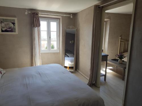 a bedroom with a large bed and a window at Le Crillon in Murs