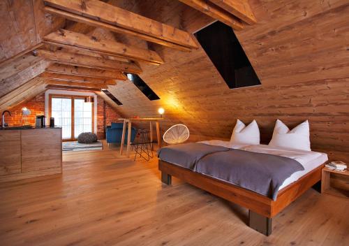 a bedroom with a bed in a room with wooden walls at meinHimmelschlüssel in Mitterbach