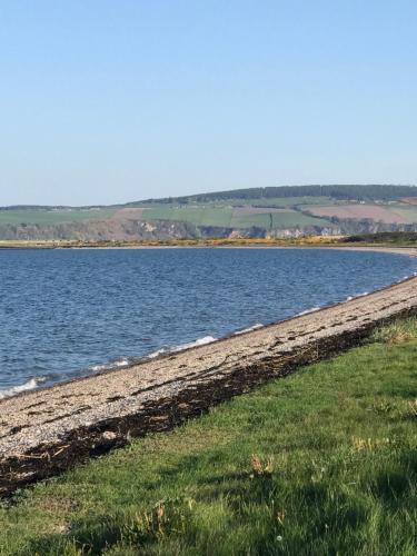 a large body of water with green grass and water at Inchrye Bed & Breakfast in Inverness