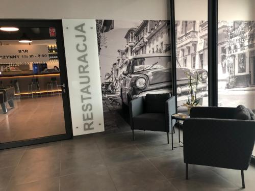a store with two chairs and a table and a sign at Hotel Picaro Kopytkowo A1 in Kopytkowo