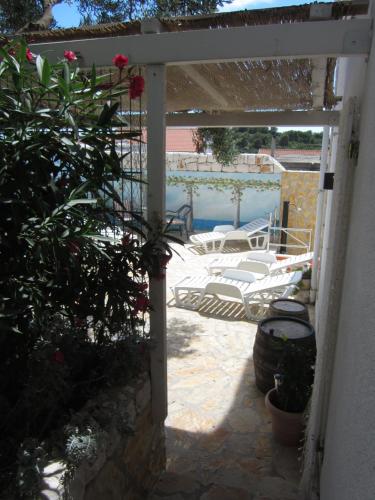 an entrance to a patio with a table and chairs at Apartments Villa Bella Vista Hvar in Hvar