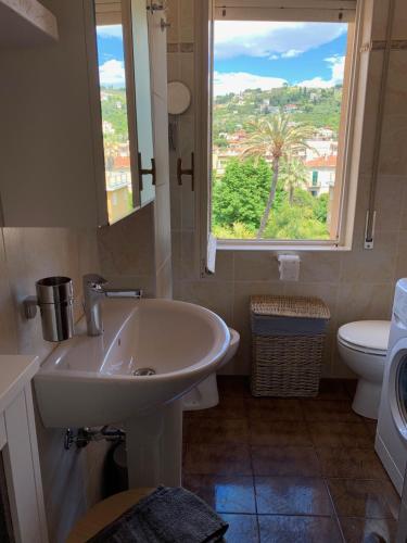 a bathroom with a sink and a window and a toilet at Ocean in Bordighera