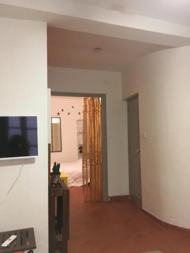 a living room with a television and a bedroom at Au coeur de Collioure in Collioure