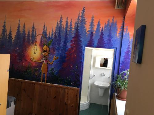 a bathroom with a painting of a forest at Chata Orlí vrch in Zlaté Hory