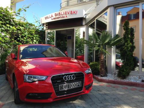a red car parked in front of a building at Villa Dislievski in Ohrid