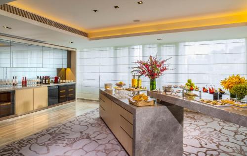 a buffet line in a hotel room with food at Fraser Suites Guangzhou in Guangzhou