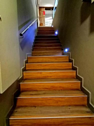 a stairway with wooden steps with lights on it at Eazy Hotel at Ampang in Batu Empat