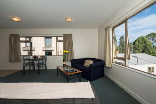 a room with a couch and a table with a chair at Lake Point Motel in Hamilton