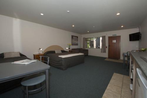 a hotel room with a bed and a couch at Lake Point Motel in Hamilton