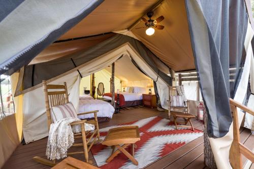 a bedroom with a tent with a bed and chairs at Westgate River Ranch Resort & Rodeo in River Ranch