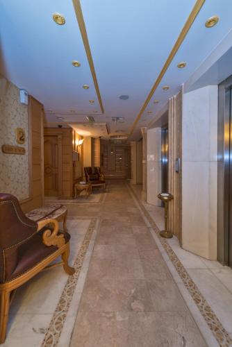 a hallway in a building with a couch and a room at Wyndham Istanbul Old City in Istanbul