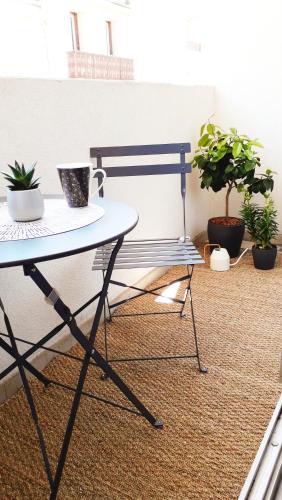 a table and some potted plants in a room at BoHémian Studio in Sète Center in Sète