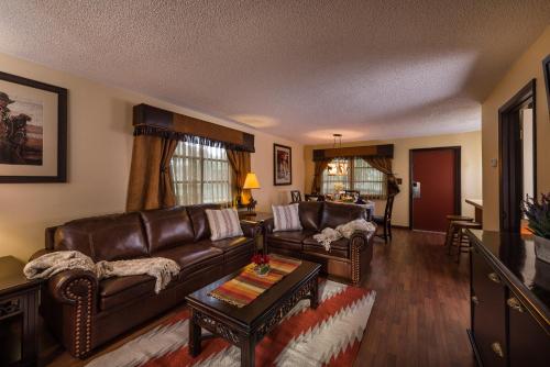 a living room with a leather couch and a table at Westgate River Ranch Resort & Rodeo in River Ranch