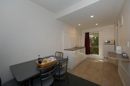 a kitchen with a counter and a table and chairs at Lake Point Motel in Hamilton