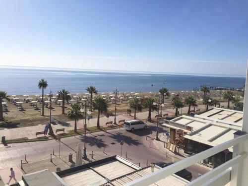 a view of a parking lot next to the ocean at Larnaka Seaview Luxury Suites in Larnaka