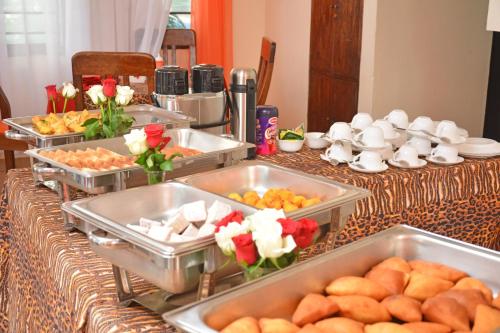 a table with several trays of food on it at Ocean View Nyali Boutique Hotel in Nyali