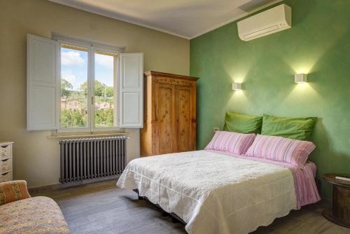 a bedroom with a bed and a window at Podere Fontecastello in Montepulciano
