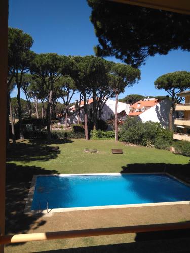 a swimming pool in a yard with trees at porta del golf in Pals